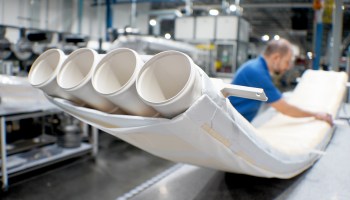 Worker inspects thermoplastic tubing