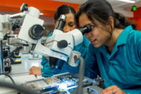 Students looking through microscope in lab