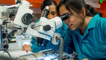 Students looking through microscope in lab